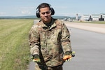 U.S. Air Force Master Sgt. Jose Marrero, noncommissioned officer in charge of airfield management with the 167th Operations Support Group, displays a pyrotechnical device with cartridges used as part of the Bird/wildlife Aircraft Strike Hazards (BASH) program, at the 167th Airlift Wing, Martinsburg, West Virginia, May 12, 2021. The airfield management team uses many noise-making devices to encourage animals to move away from the airfield.