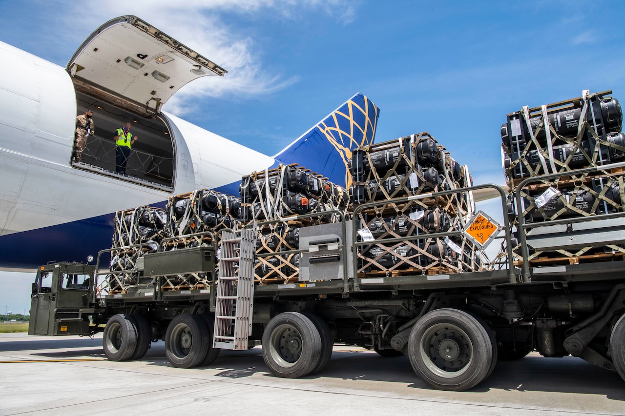 Airmen load cargo onto a plane.