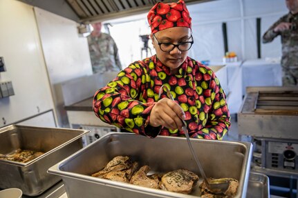 Master Sgt. Lala Kauahi prepares food during a culinary demonstration by Alaska Army National Guard culinary specialists on Joint Base Elmendorf-Richardson, May 14, as part of the Alaska Army National Guard’s new Partnership for Youth Success program. The PaYS program is a strategic partnership between the Army National Guard and a cross section of private businesses, universities, and public institutions. It provides Alaska’s newest Citizen-Soldiers the opportunity to increase their prospects for potential civilian employment while serving their country. (U.S. Army National Guard photo by Edward Eagerton)