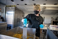 Spc. Nikole Eustice prepares food during a culinary demonstration by Alaska Army National Guard culinary specialists on Joint Base Elmendorf-Richardson, May 14, as part of the Alaska Army National Guard’s new Partnership for Youth Success program. The PaYS program is a strategic partnership between the Army National Guard and a cross section of private businesses, universities, and public institutions. It provides Alaska’s newest Citizen-Soldiers the opportunity to increase their prospects for potential civilian employment while serving their country. (U.S. Army National Guard photo by Edward Eagerton)