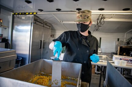 Spc. Nikole Eustice prepares food during a culinary demonstration by Alaska Army National Guard culinary specialists on Joint Base Elmendorf-Richardson, May 14, as part of the Alaska Army National Guard’s new Partnership for Youth Success program. The PaYS program is a strategic partnership between the Army National Guard and a cross section of private businesses, universities, and public institutions. It provides Alaska’s newest Citizen-Soldiers the opportunity to increase their prospects for potential civilian employment while serving their country. (U.S. Army National Guard photo by Edward Eagerton)