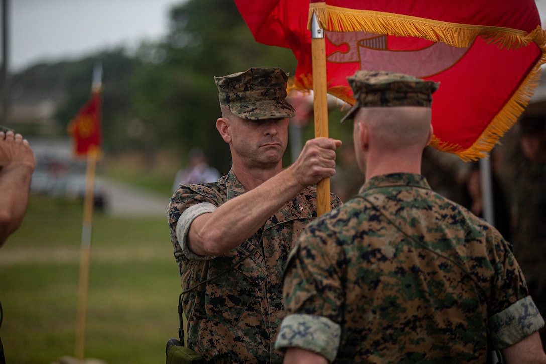 U.S. Marine Corps Col. Robert J. Hallett, left, outgoing commanding officer of 10th Marine Regiment, 2d Marine Division, relinquishes command to Col. Andrew M. Kelley, incoming commanding officer of 10th Marine Regiment, during a change of command ceremony on Camp Lejeune, N.C., June 3, 2021. The ceremony represents the transfer of authority, responsibility, and accountability from the out-going officer to the incoming commanding officer. (U.S. Marine Corps photo by Lance Cpl. Brian Bolin Jr.)