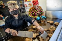 Sgt. Patricia Catacutan and Master Sgt. Lala Kauahi prepare food during a culinary demonstration by Alaska Army National Guard culinary specialists on Joint Base Elmendorf-Richardson, May 14, as part of the Alaska Army National Guard’s new Partnership for Youth Success program. The PaYS program is a strategic partnership between the Army National Guard and a cross section of private businesses, universities, and public institutions. It provides Alaska’s newest Citizen-Soldiers the opportunity to increase their prospects for potential civilian employment while serving their country. (U.S. Army National Guard photo by Edward Eagerton)