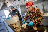 Master Sgt. Lala Kauahi prepares food during a culinary demonstration by Alaska Army National Guard culinary specialists on Joint Base Elmendorf-Richardson, May 14, as part of the Alaska Army National Guard’s new Partnership for Youth Success program. The PaYS program is a strategic partnership between the Army National Guard and a cross section of private businesses, universities, and public institutions. It provides Alaska’s newest Citizen-Soldiers the opportunity to increase their prospects for potential civilian employment while serving their country. (U.S. Army National Guard photo by Edward Eagerton)