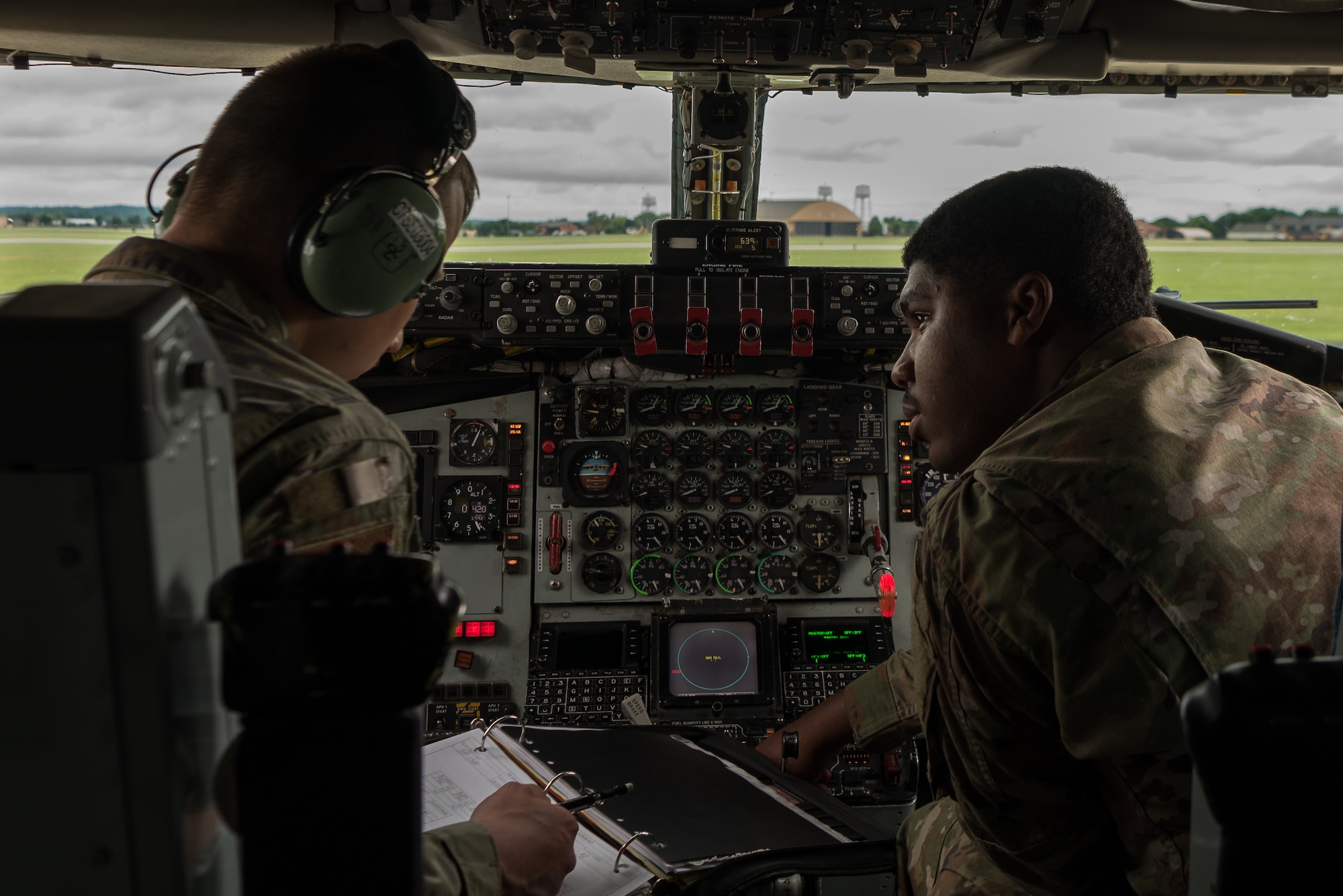 U.S. Air Force Senior Airman Sabian Scott, 906th Air Refueling Squadron KC-135 Stratotanker aerospace maintenance journeyman, and U.S. Air National Guard Airman 1st Class Brian Okoniewski 126th ARS  KC-135 aerospace maintenance journeyman, inspect the refueling panel inside of a KC-135 on Scott Air Force Base, Illinois, June 2, 2021. The refueling panel allows them to inform the Airmen outside of the aircraft when the aircraft is refueled. (U.S. Air Force photo by Airman 1st Class Mark Sulaica