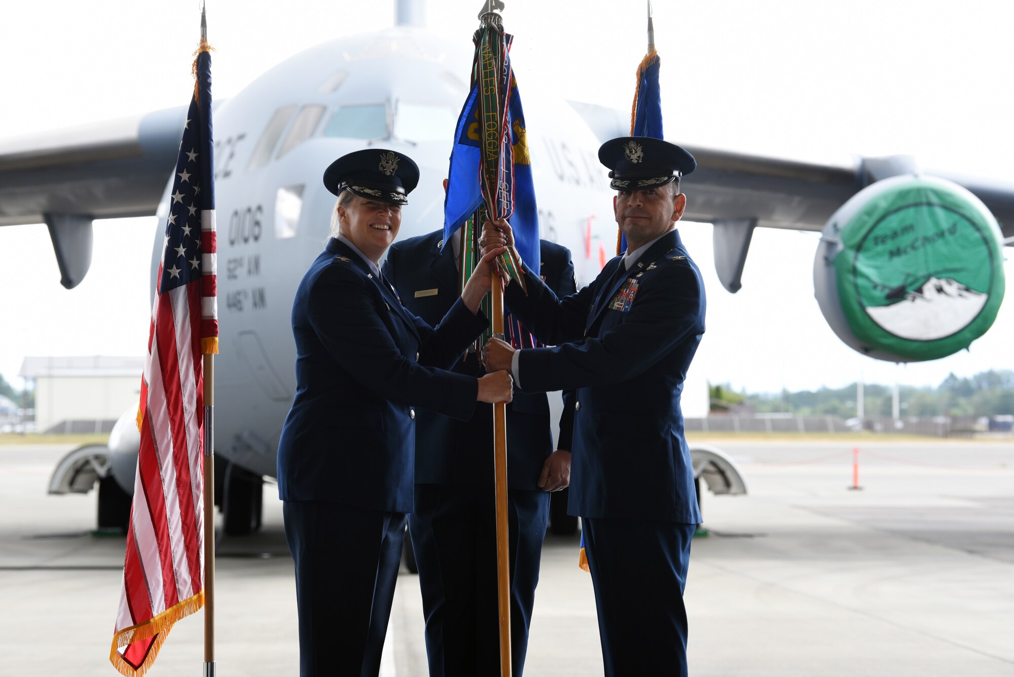 U.S. Air Force Col. Erin Staine-Pyne, 62nd Airlift Wing commander, presents the 62nd Operations Group guidon to Col. Sergio E. Anaya, the new 62nd OG commander, during the group’s assumption of command ceremony at Joint Base Lewis-McChord, Washington, June 7, 2021. As the 62nd OG commander, Anaya ensures the combat readiness of three C-17A Globemaster III airlift squadrons and an operations support squadron to conduct all aspects of C-17 operations. Anaya is a senior pilot with more than 3,800 hours in the C-17 Globemaster III, C-21A, T-1 Jayhawk, and T-37 Tweet aircraft and has logged more than 930 combat hours. (U.S. Air Force photo by Senior Airman Zoe Thacker)