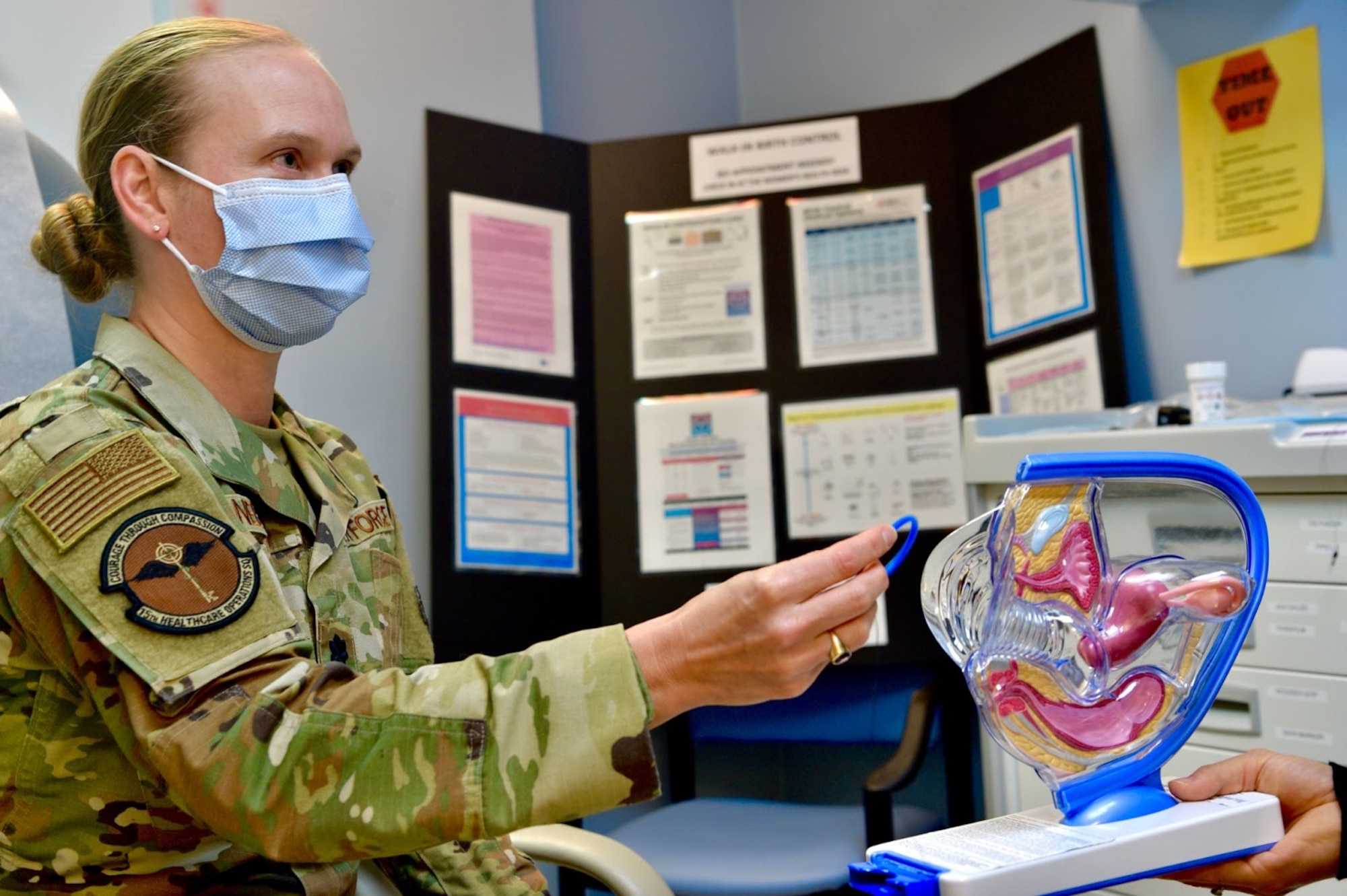 Lt. Col. Paula Neemann, 15th Healthcare Operations Squadron clinical medicine flight commander, demonstrates many birth control options, such as a birth control ring, at the 15th MDG at Joint Base Pearl Harbor-Hickam, Hawaii, May 6, 2021. The contraceptive clinic aims to educate on all types of contraceptive methods and answer any questions beneficiaries may have. (U.S. Air Force photo by 2nd Lt. Benjamin Aronson)