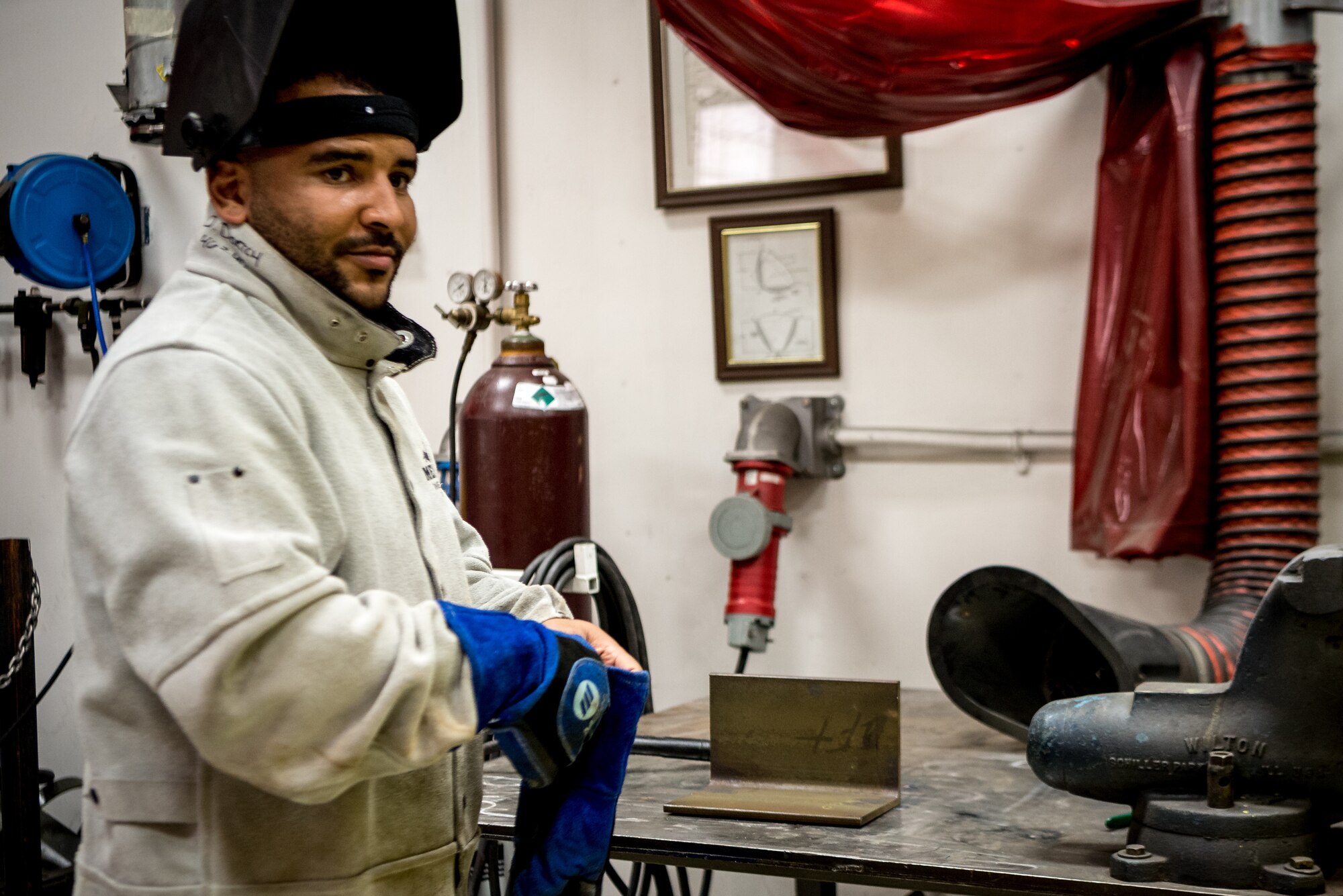 U.S. Air Force Senior Airman Doniel Dortch, 906th Aerial Refueling Squadron metals technology fabrication welder, welds a piece of metal together for an engine trainer on Scott Air Force Base, Illinois. The metal piece was a small piece that would be put onto an engine specially made for simulating real engines for training purposes.  (U.S. Air Force photo by Airman 1st Class Mark Sulaica)