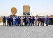 The Communications-Electronics Command Regional Support Center’s civilian team at the 401st Army Field Support Brigade gathers in front of various generators, a Trojan AN/TSQ-226B(V) Communications system, and a AN/TPQ-53 Radar at Camp Arifjan, Kuwait, May 20. The Camp Arifjan RSC’s civilian workforce worked tirelessly to rapidly establish in-theater power generator rebuild and exchange programs.