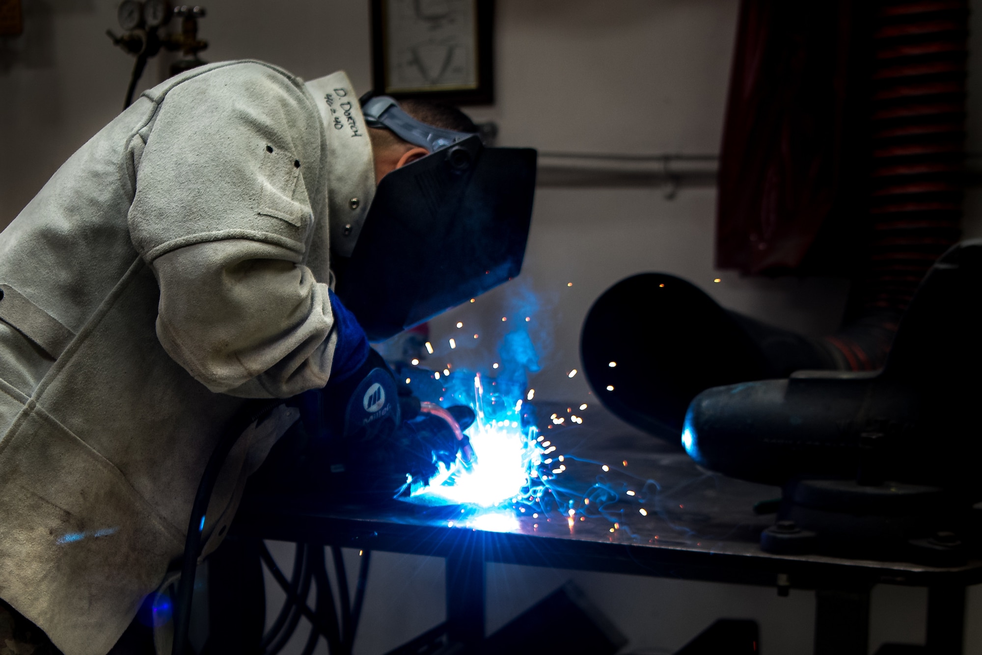 U.S. Air Force Senior Airman Doniel Dortch, 906th Aerial Refueling Squadron metals technology fabrication welder, welds a piece of metal together for an engine trainer on Scott Air Force Base, Illinois. The metal piece was a small piece that would be put onto an engine specially made for simulating real engines for training purposes.  (U.S. Air Force photo by Airman 1st Class Mark Sulaica)