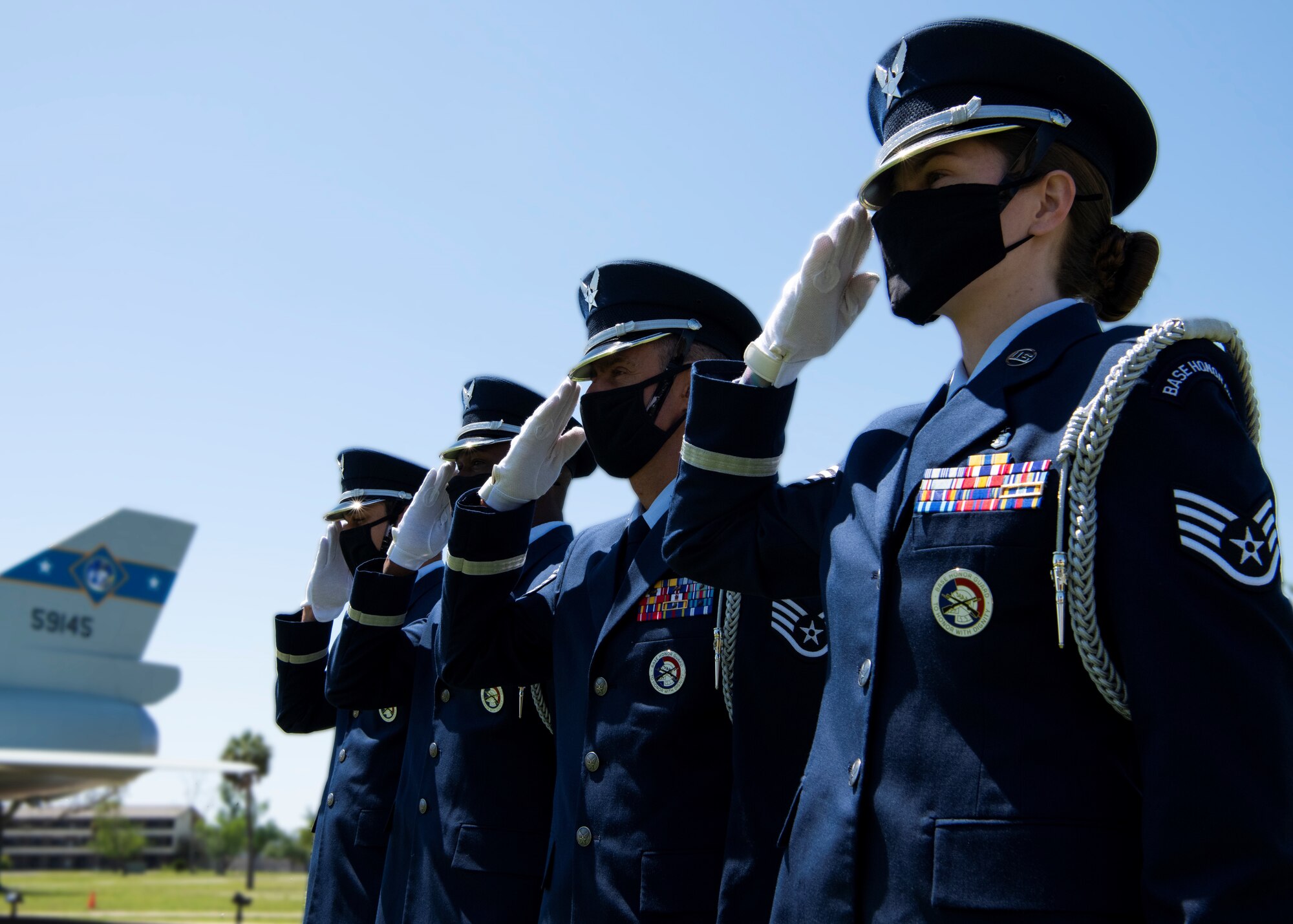 Honor guard members render a salute at Tyndall Air Force Base, Florida, April 19, 2021.