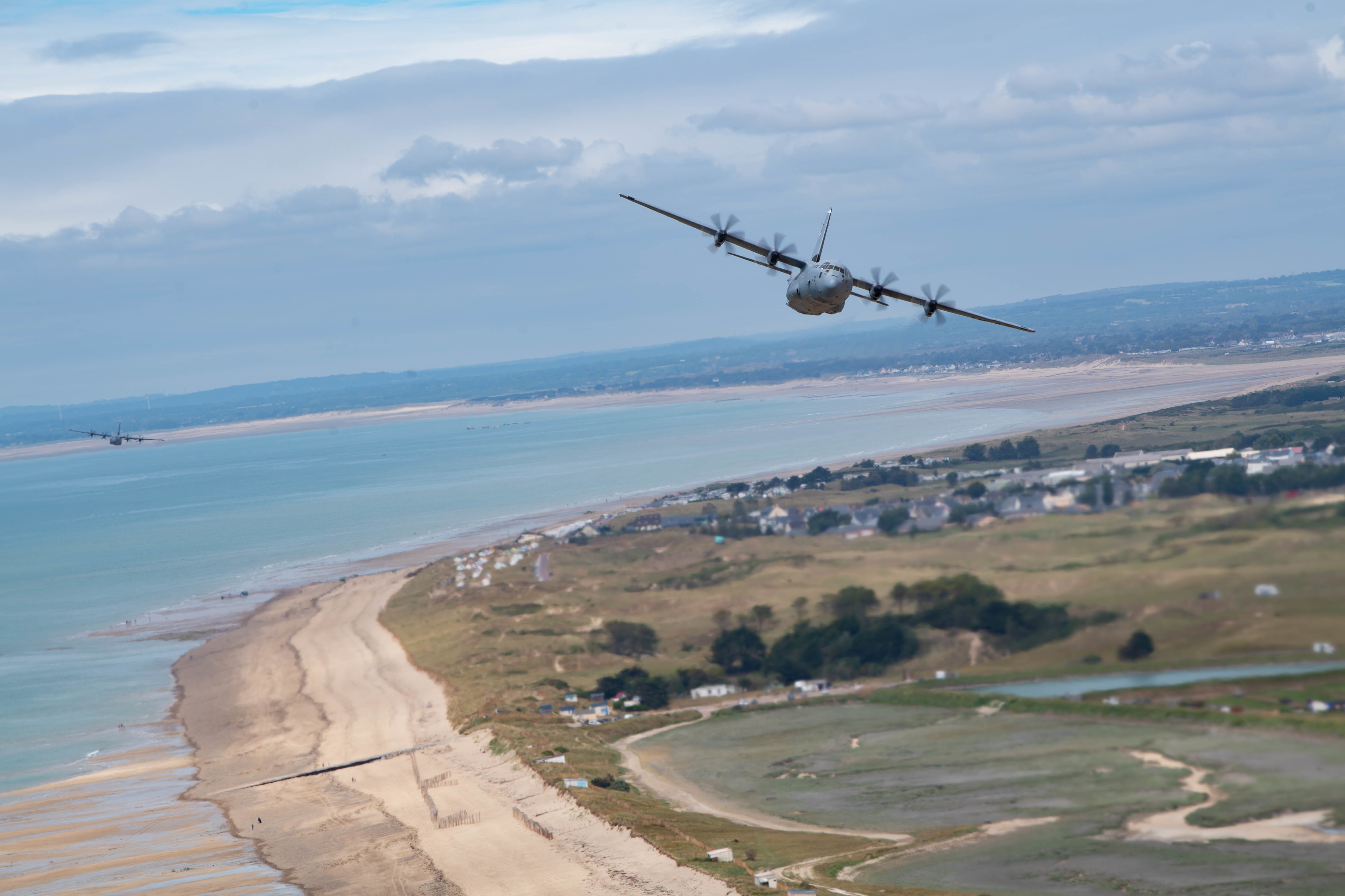 C-130J Super Hercules aircraft assigned to Ramstein Air Base, Germany, fly over the beaches of Normandy June 6, 2021.