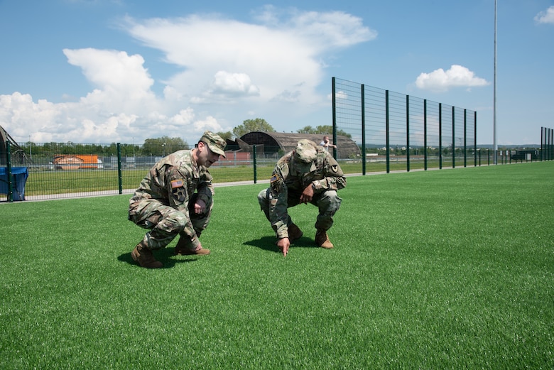 USACE Europe District commander Col. Patrick Dagon and Col. Mario A. Washington, Garrison Commander, U.S. Army Garrison (USAG) Wiesbaden inspect the new artificial turf field located at Clay North.