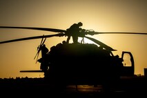 210602-A-UN662-1653 NAVAL SUPPORT ACTIVITY BAHRAIN (June 2, 2021) – Lt. Peter Fulton, assigned to Helicopter Sea Combat Squadron (HSC) 26, conducts pre-flight maintenance on an MH-60S Sea Hawk helicopter onboard Naval Support Activity Bahrain, June 2. HSC-26 is deployed to the U.S. 5th Fleet area of operations in support of naval operations to ensure maritime stability and security in the Central Region, connecting the Mediterranean and Pacific through the western Indian Ocean and three critical chokepoints to the free flow of global commerce. (U.S. Army photo by Sgt. Wheeler Brunschmid)