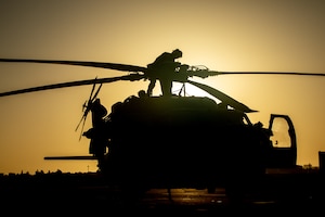 210602-A-UN662-1653 NAVAL SUPPORT ACTIVITY BAHRAIN (June 2, 2021) – Lt. Peter Fulton, assigned to Helicopter Sea Combat Squadron (HSC) 26, conducts pre-flight maintenance on an MH-60S Sea Hawk helicopter onboard Naval Support Activity Bahrain, June 2. HSC-26 is deployed to the U.S. 5th Fleet area of operations in support of naval operations to ensure maritime stability and security in the Central Region, connecting the Mediterranean and Pacific through the western Indian Ocean and three critical chokepoints to the free flow of global commerce. (U.S. Army photo by Sgt. Wheeler Brunschmid)