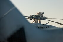 210602-A-UN662-1679 NAVAL SUPPORT ACTIVITY BAHRAIN (June 2, 2021) – Lt. Peter Fulton, assigned to Helicopter Sea Combat Squadron (HSC) 26, conducts pre-flight maintenance on an MH-60S Sea Hawk helicopter onboard Naval Support Activity Bahrain, June 2. HSC-26 is deployed to the U.S. 5th Fleet area of operations in support of naval operations to ensure maritime stability and security in the Central Region, connecting the Mediterranean and Pacific through the western Indian Ocean and three critical chokepoints to the free flow of global commerce. (U.S. Army photo by Sgt. Wheeler Brunschmid)