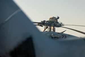 210602-A-UN662-1679 NAVAL SUPPORT ACTIVITY BAHRAIN (June 2, 2021) – Lt. Peter Fulton, assigned to Helicopter Sea Combat Squadron (HSC) 26, conducts pre-flight maintenance on an MH-60S Sea Hawk helicopter onboard Naval Support Activity Bahrain, June 2. HSC-26 is deployed to the U.S. 5th Fleet area of operations in support of naval operations to ensure maritime stability and security in the Central Region, connecting the Mediterranean and Pacific through the western Indian Ocean and three critical chokepoints to the free flow of global commerce. (U.S. Army photo by Sgt. Wheeler Brunschmid)
