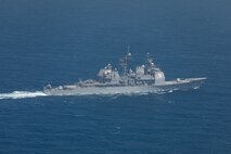 210602-A-UN662-1854 ARABIAN GULF (June 2, 2021) – Guided-missile cruiser USS Monterey (CG 61) refuels an MH-60S Sea Hawk helicopter, attached to Helicopter Sea Combat Squadron (HSC) 26, in the Arabian Gulf, June 2. HSC-26 is deployed to the U.S. 5th Fleet area of operations in support of naval operations to ensure maritime stability and security in the Central Region, connecting the Mediterranean and Pacific through the western Indian Ocean and three critical chokepoints to the free flow of global commerce. (U.S. Army photo by Sgt. Wheeler Brunschmid)