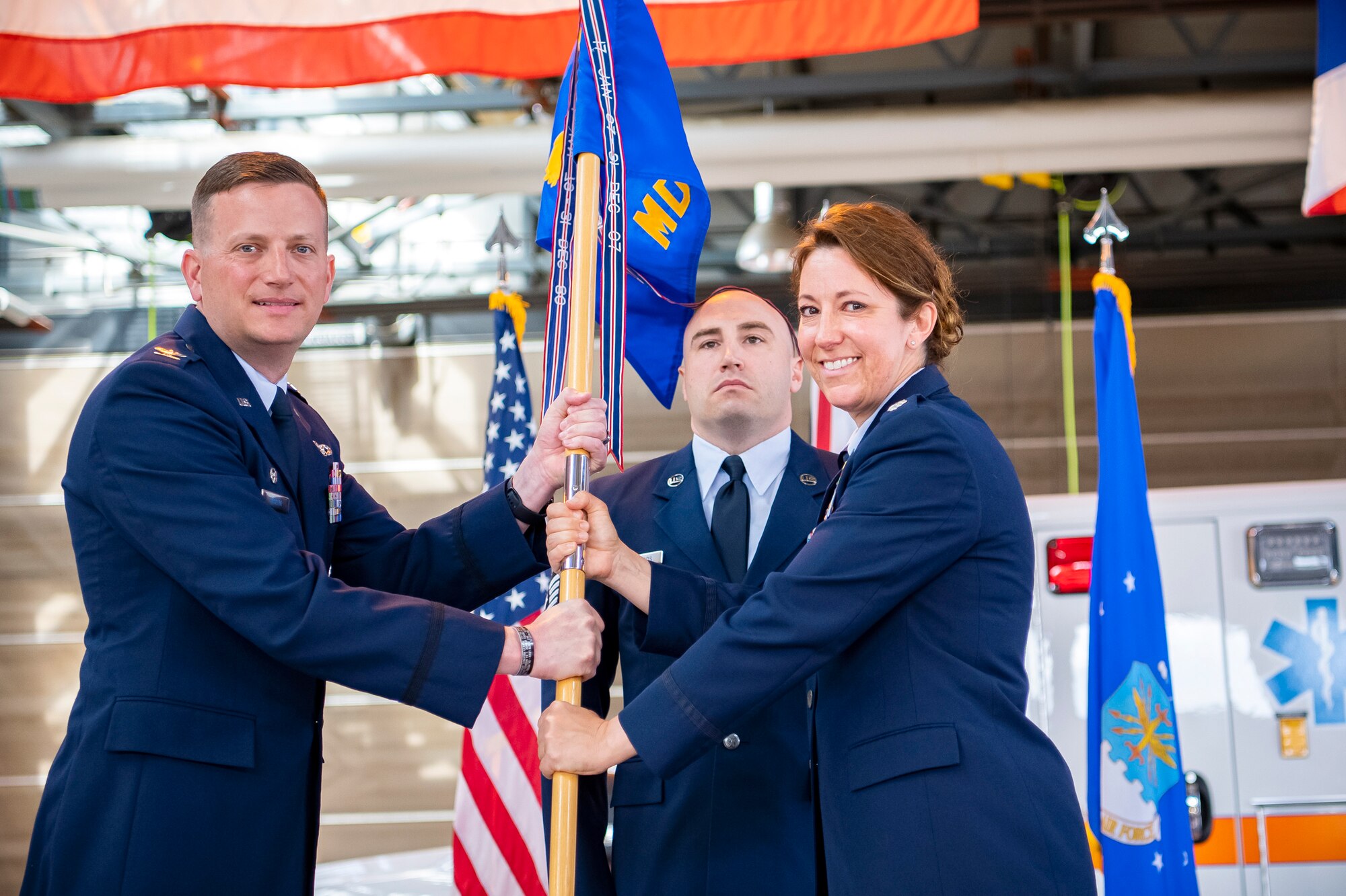 U.S. Air Force Col. Richard Martin, 423rd Air Base Group commander, receives the 423rd Medical Squadron guidon from Lt. Col. Elizabeth Hoettels, 423rd MDS outgoing commander during a change of command ceremony at RAF Alconbury, England, June 7, 2021. The ceremony is a military tradition that represents a formal transfer of a unit’s authority and responsibility from one commander to another. (U.S. Air Force photo by Senior Airman Eugene Oliver)