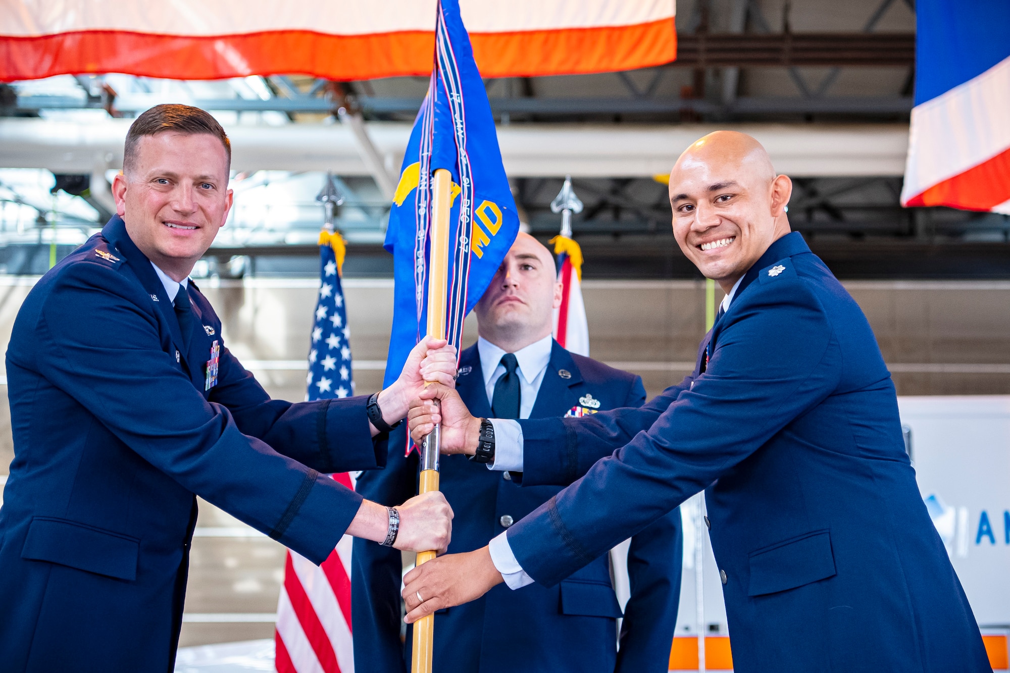 U.S. Air Force Col. Richard Martin, 423rd Air Base Group commander, presents the 423rd Medical Squadron guidon to Lt. Col. Darrell Lee, 423rd MDS incoming commander, during a change of command ceremony at RAF Alconbury, England, June 7, 2021. Prior to assuming command of the 423rd MDS, Lee served as the clinical management flight commander for the 18th Aeromedical Evacuation Squadron, Kadena Air Base, Japan. (U.S. Air Force photo by Senior Airman Eugene Oliver)