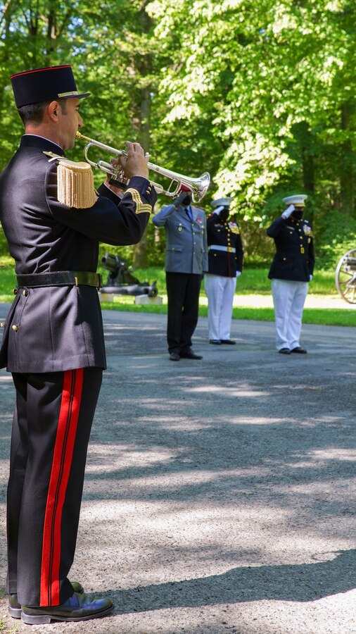 A French bugler plays taps during a wreath laying ceremony at the Iron Mike statue near Belleau, France, May 30, 2021. The ceremony was held Memorial Day weekend in commemoration of the 103rd anniversary of the battle of Belleau Wood, conducted to honor the legacy of service members who gave their lives in defense of the United States and European allies. (U.S. Marine Corps photo by Staff Sgt. Brytani Musick)