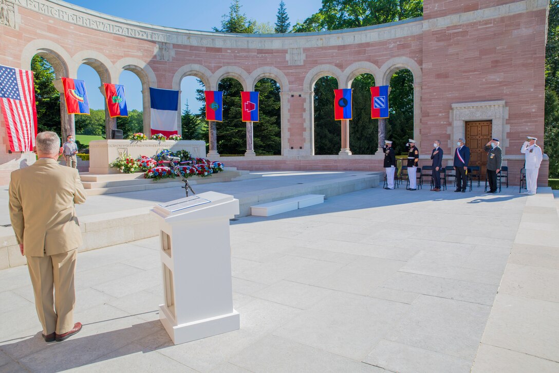 Partipants render honors for the U.S. National Anthem during a ceremony at the Oise-Aisne American Cemetery near Seringes-et-Nesles, France, May 30, 2021. The ceremony was held Memorial Day weekend in commemoration of the 103rd anniversary of the battle of Belleau Wood, conducted to honor the legacy of service members who gave their lives in defense of the United States and European allies. This was the first time since the battle over a century ago that U.S. Marine Corps, U.S. Army, U.S. Navy, French, and German service members were all present for the ceremonies. (U.S. Marine Corps photo by Staff Sgt. Brytani Musick)
