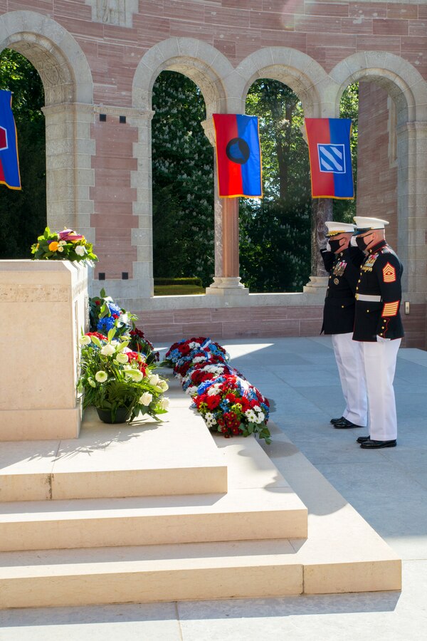 Maj. Gen. Tracy W. King, Marine Forces Europe and Africa commander, and Sgt. Maj. Aaron G. McDonald, MARFOREUR/AF sergeant major, salute wreaths laid at Oise-Aisne American Cemetery near Seringes-et-Nesles, France, May 30, 2021. The ceremony was held Memorial Day weekend in commemoration of the 103rd anniversary of the battle of Belleau Wood, conducted to honor the legacy of service members who gave their lives in defense of the United States and European allies. This was the first time since the battle over a century ago that U.S. Marine Corps, U.S. Army, U.S. Navy, French, and German service members were all present for the ceremonies. (U.S. Marine Corps photo by Staff Sgt. Brytani Musick)
