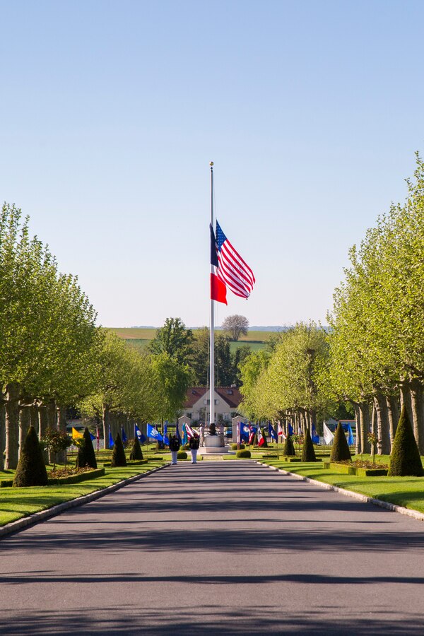 The American and French flags are raised during a ceremony at the Oise-Aisne American Cemetery near Seringes-et-Nesles, France, May 30, 2021. The ceremony was held Memorial Day weekend in commemoration of the 103rd anniversary of the battle of Belleau Wood, conducted to honor the legacy of service members who gave their lives in defense of the United States and European allies. This was the first time since the battle over a century ago that U.S. Marine Corps, U.S. Army, U.S. Navy, French, and German service members were all present for the ceremonies. (U.S. Marine Corps photo by Staff Sgt. Brytani Musick)