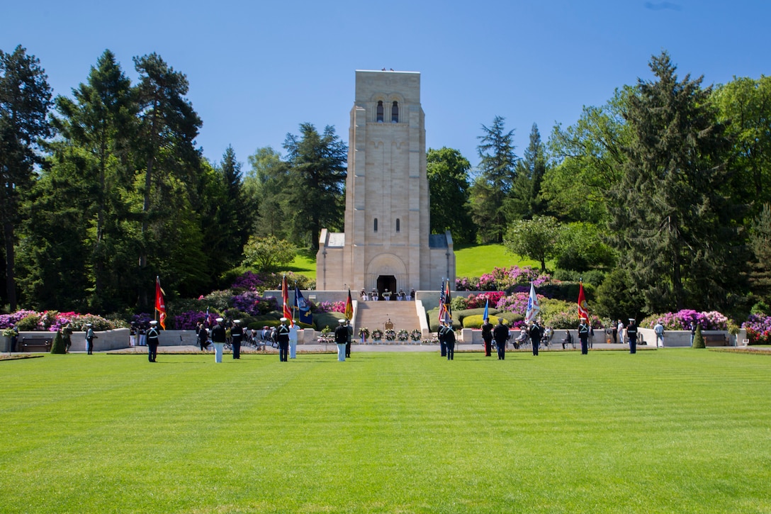 Vistors gather during a ceremony at Aisne-Marne American Cemetery in Belleau, France, May 30, 2021. The ceremony was held Memorial Day weekend in commemoration of the 103rd anniversary of the battle of Belleau Wood, conducted to honor the legacy of service members who gave their lives in defense of the United States and European allies. 

U.S. Marines and Sailors from Marine Corps Forces Europe and Africa, 5th Marine Regiment, 6th Marine Regiment, 1st Marine Division band, U.S. Soldiers from the Army 26th Infantry Division, 2nd Infantry Division representatives, German and French service members, and local officials participated in the ceremony. The joint color guard included the U.S. Army colors, a first for the historic ceremony. This was the first time since the battle over a century ago that U.S. Marine Corps, U.S. Army, U.S. Navy, French, and German service members were all present for the ceremonies.  (U.S. Marine Corps photo by Staff Sgt. Brytani Musick)