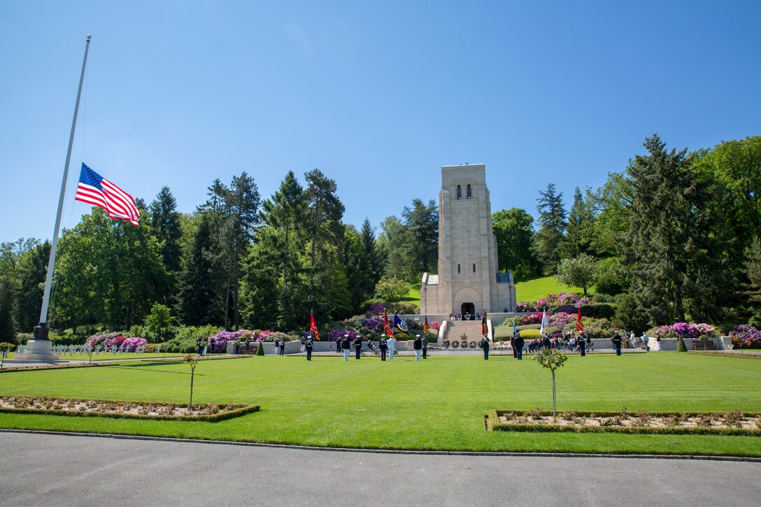 Vistors gather during a ceremony at Aisne-Marne American Cemetery in Belleau, France, May 30, 2021. The ceremony was held Memorial Day weekend in commemoration of the 103rd anniversary of the battle of Belleau Wood, conducted to honor the legacy of service members who gave their lives in defense of the United States and European allies. U.S. Marines and Sailors from Marine Corps Forces Europe and Africa, 5th Marine Regiment, 6th Marine Regiment, 1st Marine Division band, U.S. Soldiers from the Army 26th Infantry Division, 2nd Infantry Division representatives, German and French service members, and local officials participated in the ceremony. The joint color guard included the U.S. Army colors, a first for the historic ceremony. This was the first time since the battle over a century ago that U.S. Marine Corps, U.S. Army, U.S. Navy, French, and German service members were all present for the ceremonies.  (U.S. Marine Corps photo by Staff Sgt. Brytani Musick)