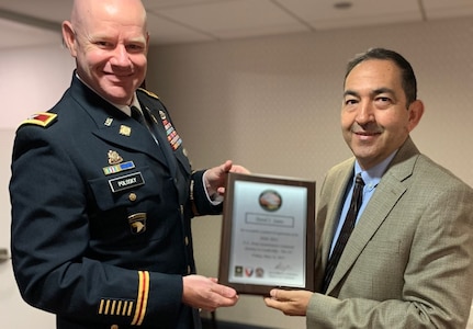 Army Col. Kevin Polosky, the deputy chief of staff for operations at U.S. Army Sustainment Command, presents David Saenz, the chief of plans and operations at the 405th Army Field Support Brigade’s Logistics Readiness Center Bavaria, with his graduation certificate. Saenz and 12 other AMC employees graduated Journey to Leadership Level III recently. The JLT program is designed to prepare high-potential future leaders for key positions through mission overviews, contact with senior leaders, coaching and networking.