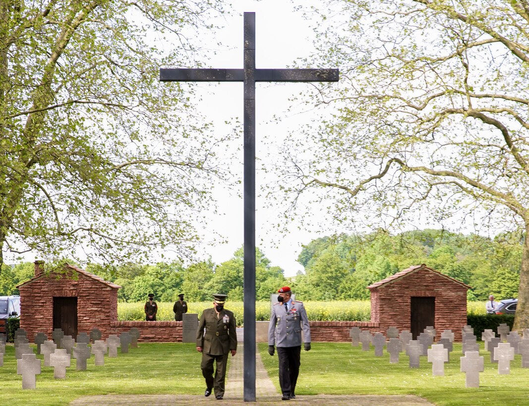 Maj. Gen. Tracy W. King, Marine Forces Europe and Africa commander, and Brig. Gen. Michael Podzus, German Army, salute wreaths laid in honor of the German service members killed during World War I, during an event at the German cemetery near Belleau, France, May 29, 2021. U.S. Marines are in France to commemorate the 103rd anniversary of the battle of Belleau Wood during a Memorial Day service at the local American cemeteries. (U.S. Marine Corps photo by Staff Sgt. Brytani Musick)