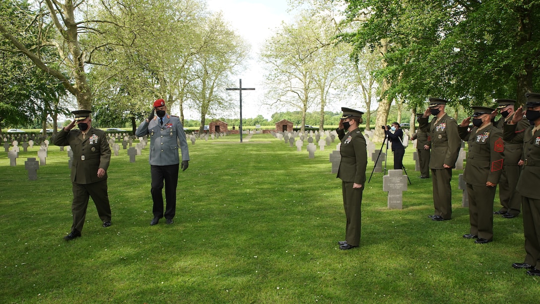 Maj. Gen. Tracy W. King, Marine Forces Europe and Africa commander, and Brig. Gen. Michael Podzus, German Army, salute wreaths laid in honor of the German service members killed during World War I, during an event at the German cemetery near Belleau, France, May 29, 2021. U.S. Marines are in France to commemorate the 103rd anniversary of the battle of Belleau Wood during a Memorial Day service at the local American cemeteries. (U.S. Marine Corps photo by Staff Sgt. Brytani Musick)