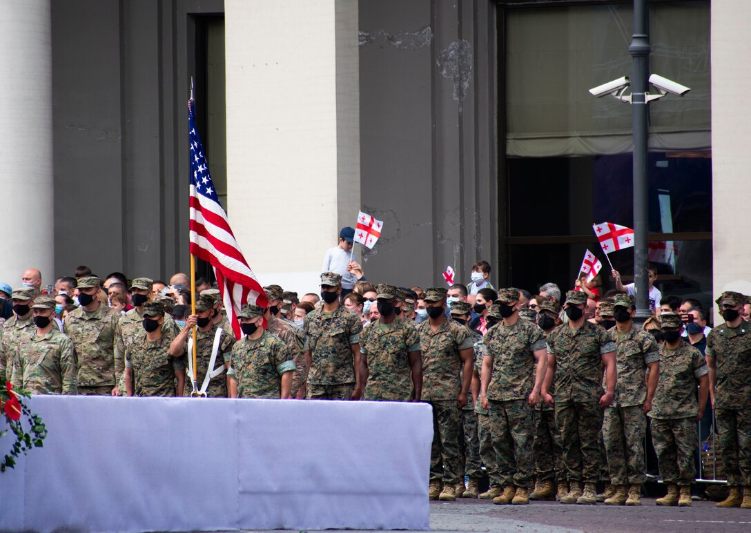 U.S. Marines and Army Soldiers stand at attention during a Georgian Independence Day ceremony at Freedom Square in Tbilisi, Georgia, on May 26, 2021. On this day, Georgia celebrates the adoption of the Act of Independence, which established the Democratic Republic of Georgia in 1918. This is also the country’s 30th year as a free and independent nation since its separation from the former Soviet Union.  Marines from the 13th rotation of the Georgia Deployment Program-Resolute Support Mission, Georgia Training Team, and Soldiers from the 2nd Battalion, 5th Calvary Regiment, 1st Calvary Division were the only foreign servicemembers invited to participate together with the troops of the Georgian Defence Forces during the celebration. These Marines represent the final GDP rotation to Georgia before the mission is sunset in the fall of this year due to the decision for U.S. troops to leave Afghanistan. For the past 17 years, U.S. Marines and Georgian troops have trained and deployed together, even fighting side-by-side, in support of various missions in the Middle East. (U.S. Marine Corps photo by Sgt. Kirstin Spanu)