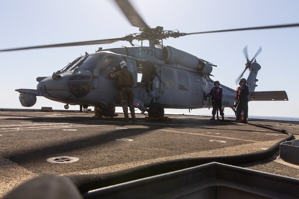 210602-A-UN662-1776 ARABIAN GULF (June 2, 2021) – An MH-60S Sea Hawk helicopter, attached to Helicopter Sea Combat Squadron (HSC) 26, refuels on the flight deck of guided-missile cruiser USS Monterey (CG 61) in the Arabian Gulf, June 2. HSC-26 is deployed to the U.S. 5th Fleet area of operations in support of naval operations to ensure maritime stability and security in the Central Region, connecting the Mediterranean and Pacific through the western Indian Ocean and three critical chokepoints to the free flow of global commerce. (U.S. Army photo by Sgt. Wheeler Brunschmid)