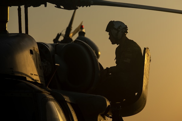 210602-A-UN662-1636 NAVAL SUPPORT ACTIVITY BAHRAIN (June 2, 2021) – Naval Aircrewman (Helicopter) 2nd Class Daniel Sawitsky, assigned to Helicopter Sea Combat Squadron (HSC) 26, conducts pre-flight maintenance on an MH-60S Sea Hawk helicopter onboard Naval Support Activity Bahrain, June 2. HSC-26 is deployed to the U.S. 5th Fleet area of operations in support of naval operations to ensure maritime stability and security in the Central Region, connecting the Mediterranean and Pacific through the western Indian Ocean and three critical chokepoints to the free flow of global commerce. (U.S. Army photo by Sgt. Wheeler Brunschmid)