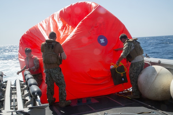 210602-A-MU580-1061 ARABIAN GULF (June 2, 2021) - Sailors assigned to Commander, Task Force (CTF) 56 deploy a “killer tomato” inflatable target during a live-fire exercise as part of an air operations in support of maritime surface warfare (AOMSW) exercise in the Arabian Gulf, June 2. CTF 56 commands and controls the employment of tactical Navy expeditionary combat forces in order to maximize U.S. 5th Fleet’s lethality throughout the maritime domain utilizing eight task groups whose missions range from explosive ordnance disposal and salvage diving, Army civil affairs, Naval construction forces and expeditionary logistics support, maritime interdiction operations and maritime security, and embarked security teams. (U.S. Army photo by Spc. Zion Thomas)