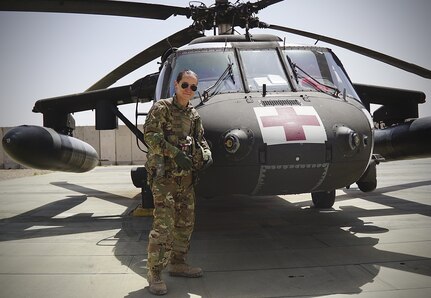 Staff Sgt. Brianna Pritchard, an Army National Guard UH-60 Black Hawk helicopter mechanic from Anchorage, Alaska, in front of a Task Force Phoenix UH-60 Black Hawk medevac helicopter as Al Asad Air Base, Iraq. Pritchard is training to qualify for the 2024 Paris Olympics in breaking.