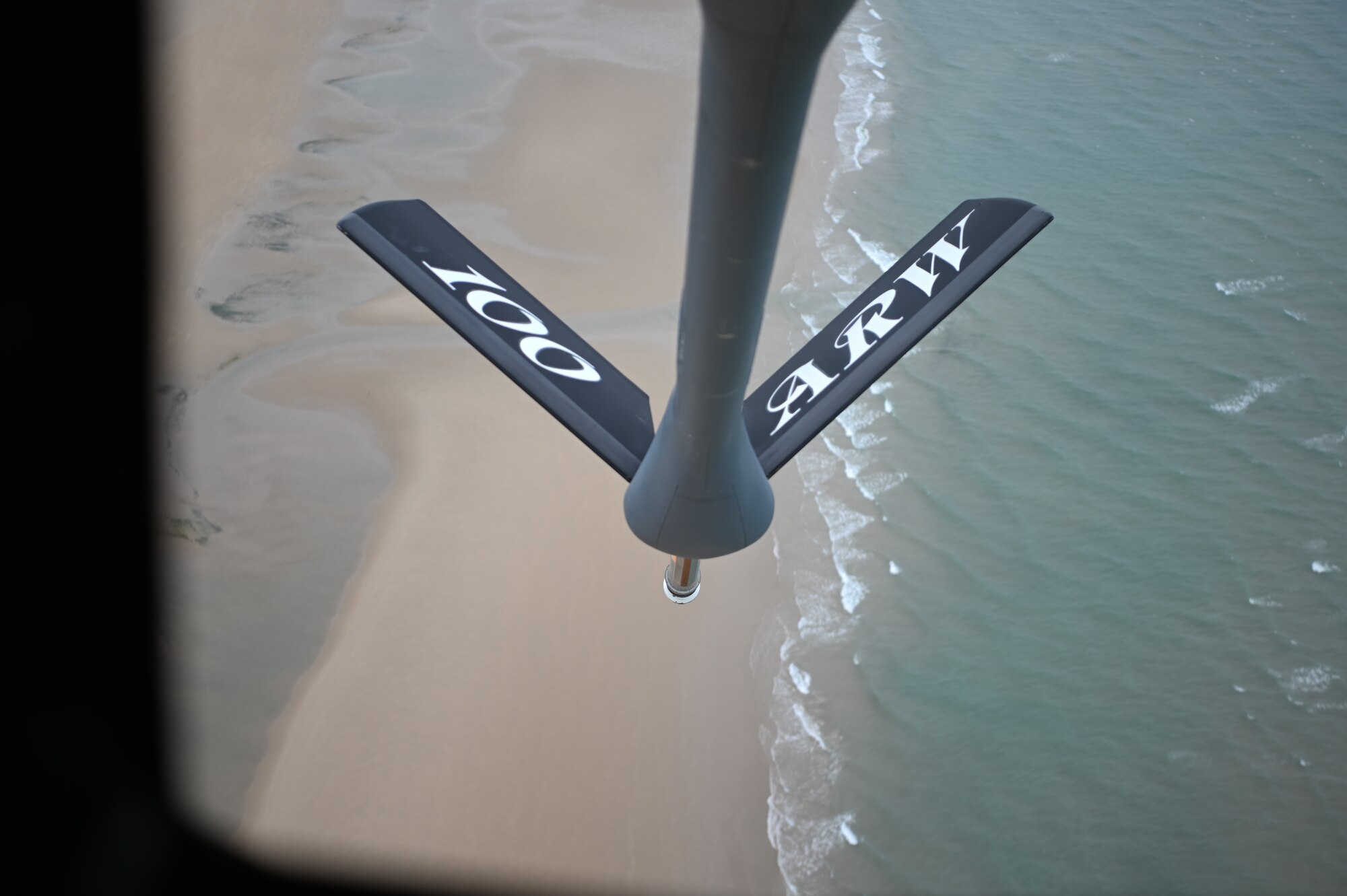 The boom of a KC-135 Stratotanker hangs over Omaha Beach, France, June 4, 2021. Omaha Beach was the flyover location to honor Charles Norman Shay, who served as a medical technician, as well as tended to the injured on the first wave attack of Omaha Beach. (U.S. Air Force photo by Staff Sgt. Matthew J. Wisher)