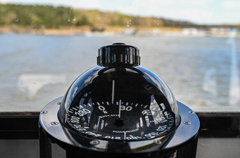 The compass aboard a U.S. Army ship points towards open water at 3rd Port, Joint Base Langley-Eustis, Virginia, April 2, 2021. The ship was used to shuttle Soldiers and supplies across the channel while equipment was loaded for an upcoming deployment. (U.S. Air Force photo by Senior Airman Sarah Dowe)