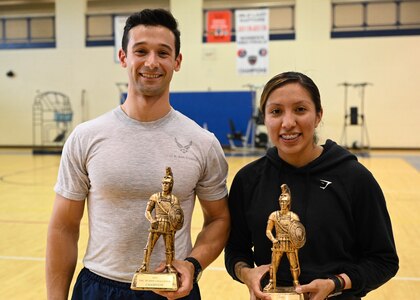 Two Airmen posing with trophies
