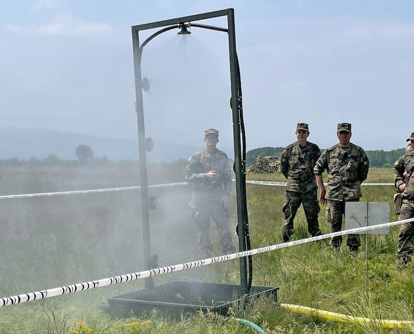 U.S. Army Reserve Lt. Col. Mary J. Durham, commander of the 773rd Civil Support Team, 7th Mission Support Command, left, observes chemical, biological, radiological, nuclear decontamination shower procedures alongside Soldiers from the Bulgarian Army's 38th CBRN Defence Battalion during a military-to-military exchange held in Sofia, Bulgaria, May 25-28, 2021. The event was designed to enhance relationships and interoperability with Allies and partner nations. (U.S. Army Reserve photo by Staff Sgt. Christopher Branning, 773rd CST)