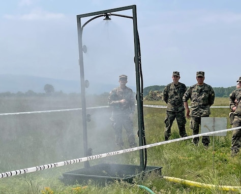 U.S. Army Reserve Lt. Col. Mary J. Durham, commander of the 773rd Civil Support Team, 7th Mission Support Command, left, observes chemical, biological, radiological, nuclear decontamination shower procedures alongside Soldiers from the Bulgarian Army's 38th CBRN Defence Battalion during a military-to-military exchange held in Sofia, Bulgaria, May 25-28, 2021. The event was designed to enhance relationships and interoperability with Allies and partner nations. (U.S. Army Reserve photo by Staff Sgt. Christopher Branning, 773rd CST)