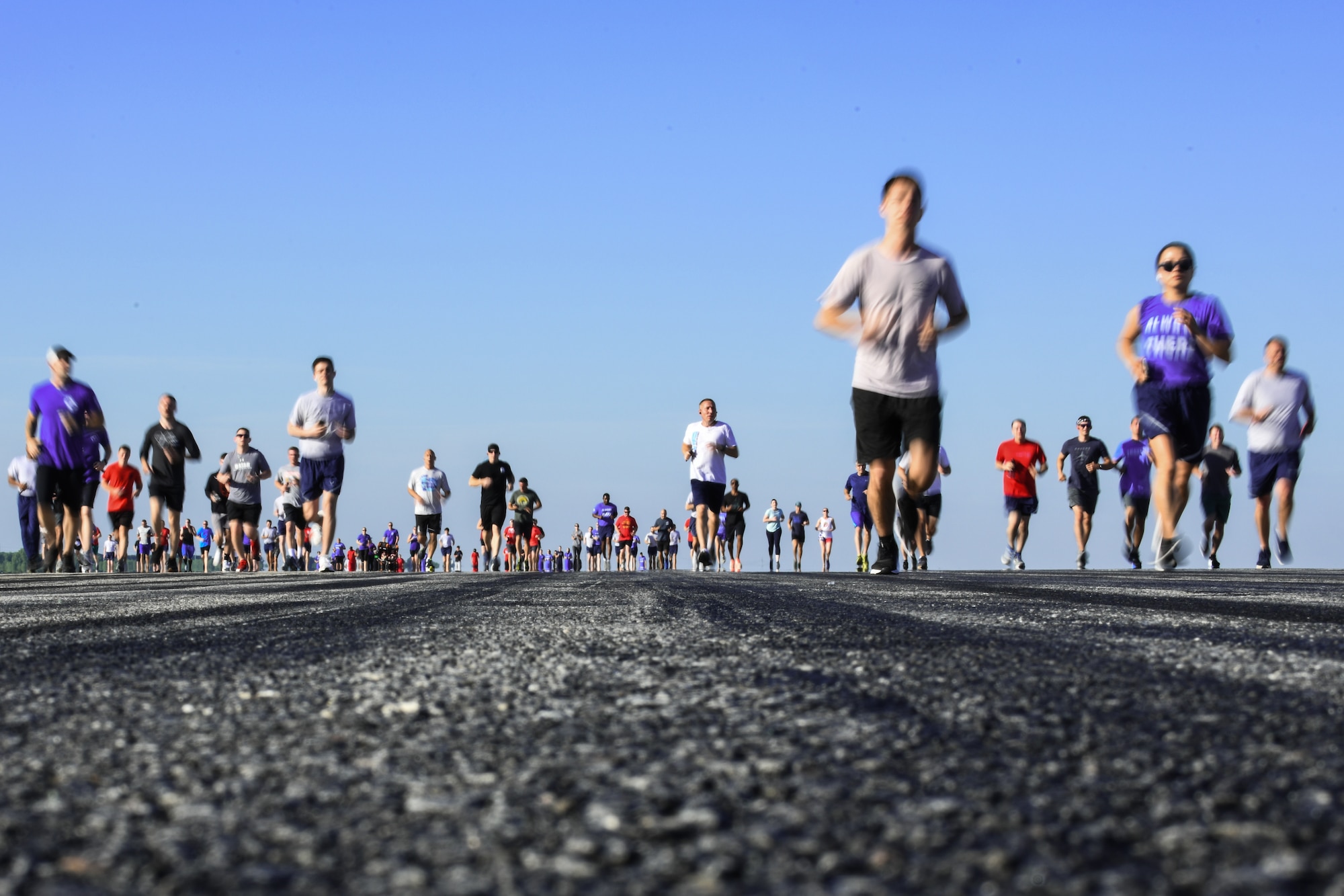 Team McConnell Airmen and family jog during the first annual Run-the-Runway event June 4, 2021, at McConnell Air Force Base, Kansas. Approximately 350 participants ran the morale-boosting event that was hosted by the 22nd Operations Group. (U.S. Air Force photo by Senior Airman Alan Ricker)