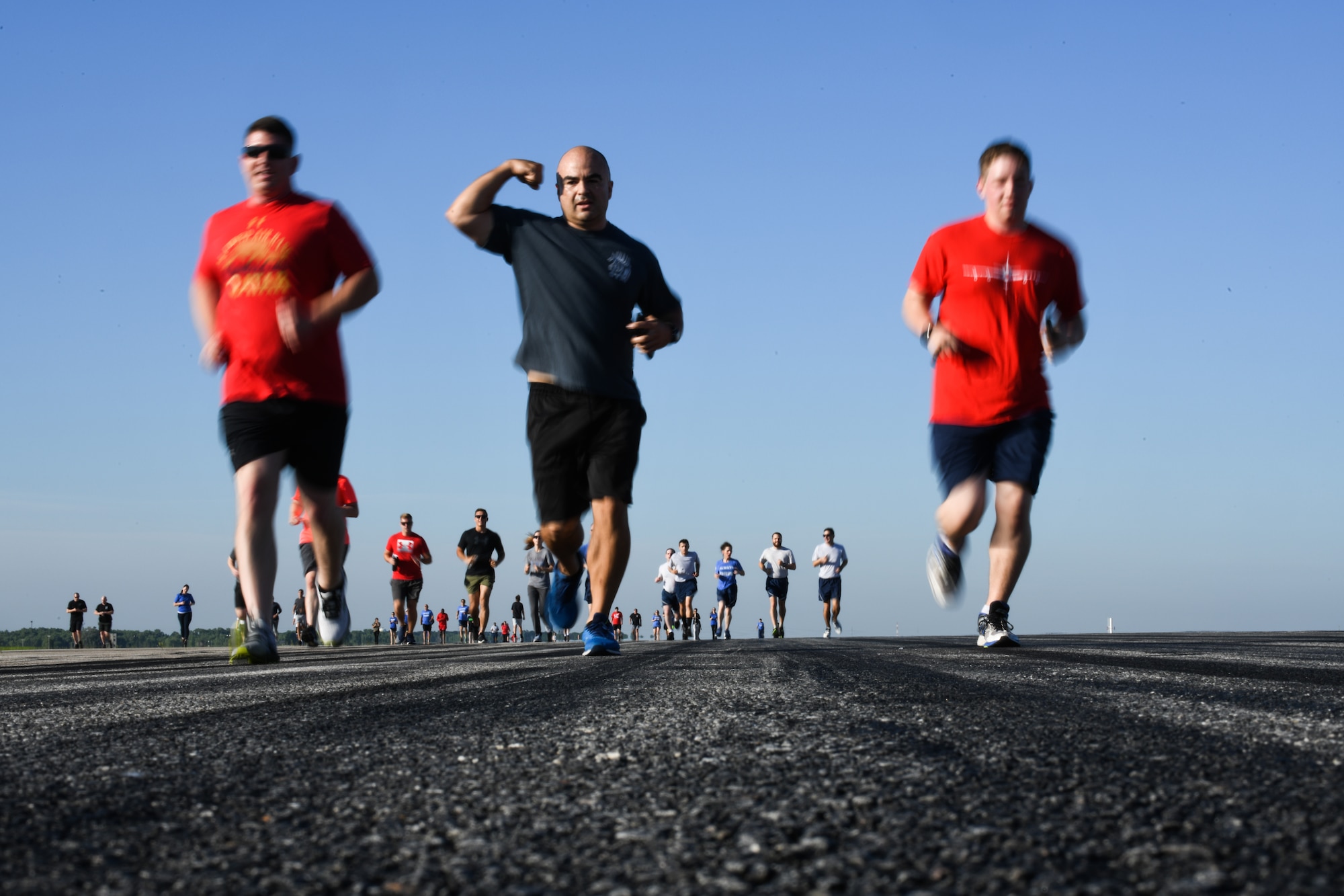 Team McConnell Airmen and family run during the first annual Run-the-Runway event June 4, 2021, at McConnell Air Force Base, Kansas. Awards were presented to the top three women and men that completed the 5k run. (U.S. Air Force photo by Senior Airman Alan Ricker)