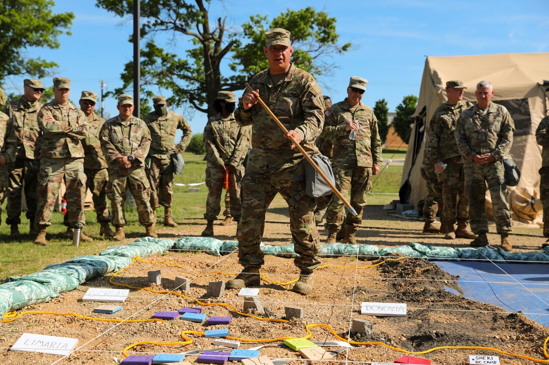 U.S. Army Reserve Maj. Richard Flores, 358th Civil Affairs Brigade, briefs the phases of battle to the staff during the and for Command Post Exercise – Functional (CPX-F) 21-02 Rehearsal of Concept drill at Ft. McCoy, Wis., June 5, 2021. CPX-F brings units from across the command together to work in cooperation in an exercise scenario that mirrors real-world mission concerns.