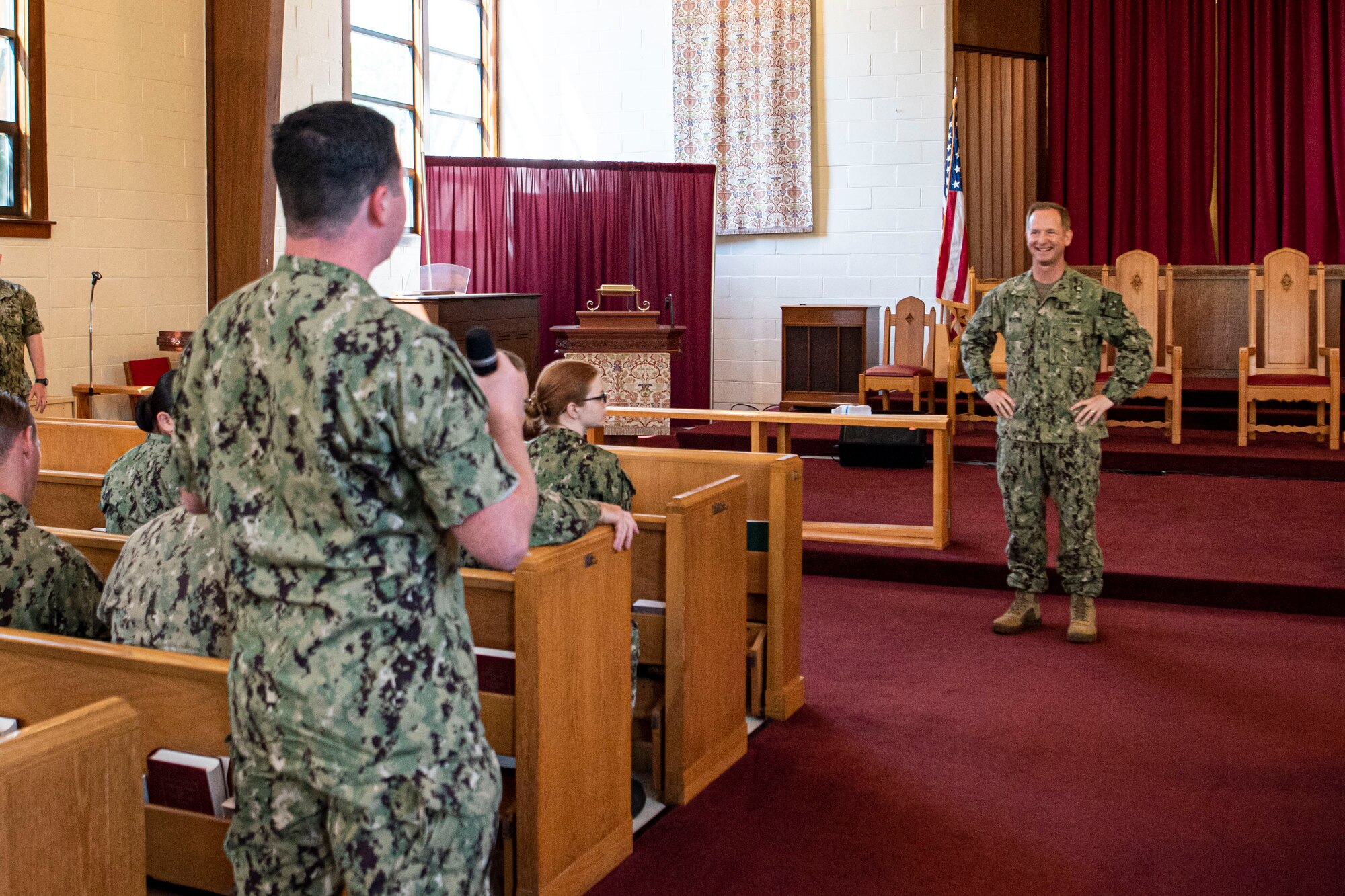 Photo of a Sailor speaking to another Sailor.