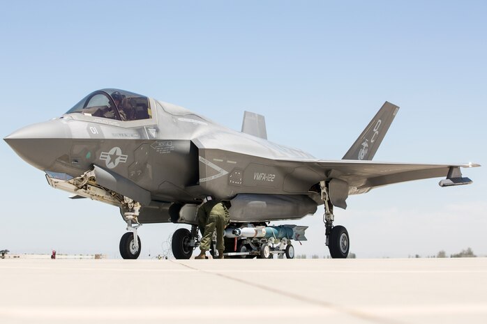 U.S. Marines with Marine Fighter Attack Squadron 122, Marine Aircraft Group 13, 3rd Marine Aircraft Wing, attach ordnance to an F-35B Lightning II at a Forward Arming and Refueling Point in El Centro, Calif., May 26, 2021. A FARP is a key component of expeditionary advanced base operations as it allows the Marine Corps to refuel, rearm and distribute in a forward environment as the Marine Corps is a force capable of persisting and operating forward as a critical component of a naval campaign.