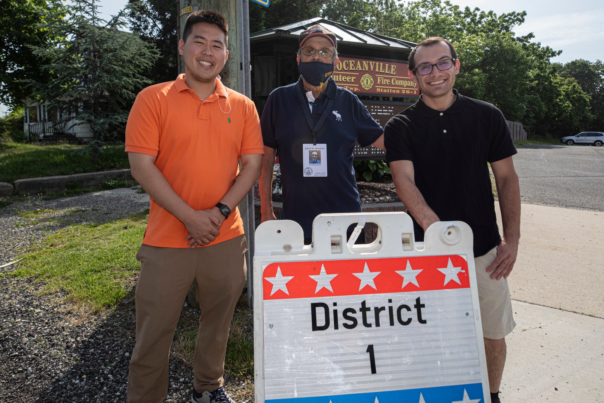 U.S. Air Force 1st Lt. Johnathon Kim, 177th Medical Group, left, John W. Mooney, Commissioner, Atlantic County Board of Elections, and Airman 1st Class Angel Castillo, 177th Aircraft Maintenance Squadron stand for a portrait in front of the Oceanville Volunteer Fire Company polling site in Galloway Township, N.J., June 8, 2021.