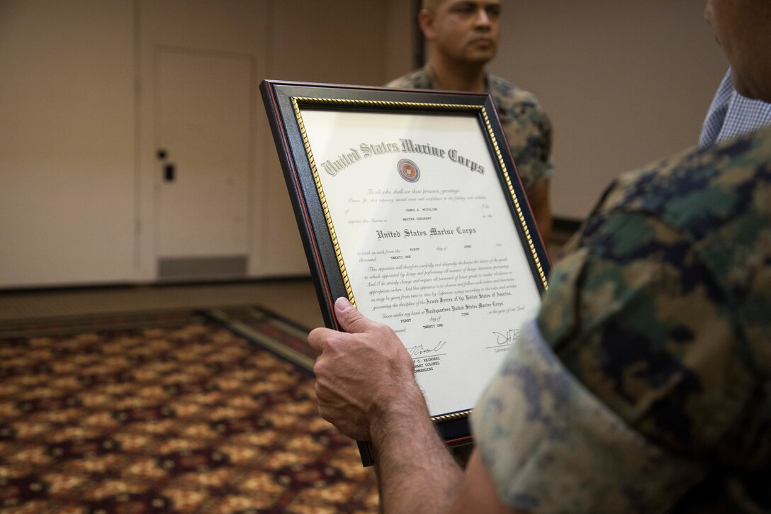 U.S. Marine Corps Master Sgt. James McFaline is read his promotion warrant during a ceremony on Marine Corps Air Station Yuma, June 4, 2021.